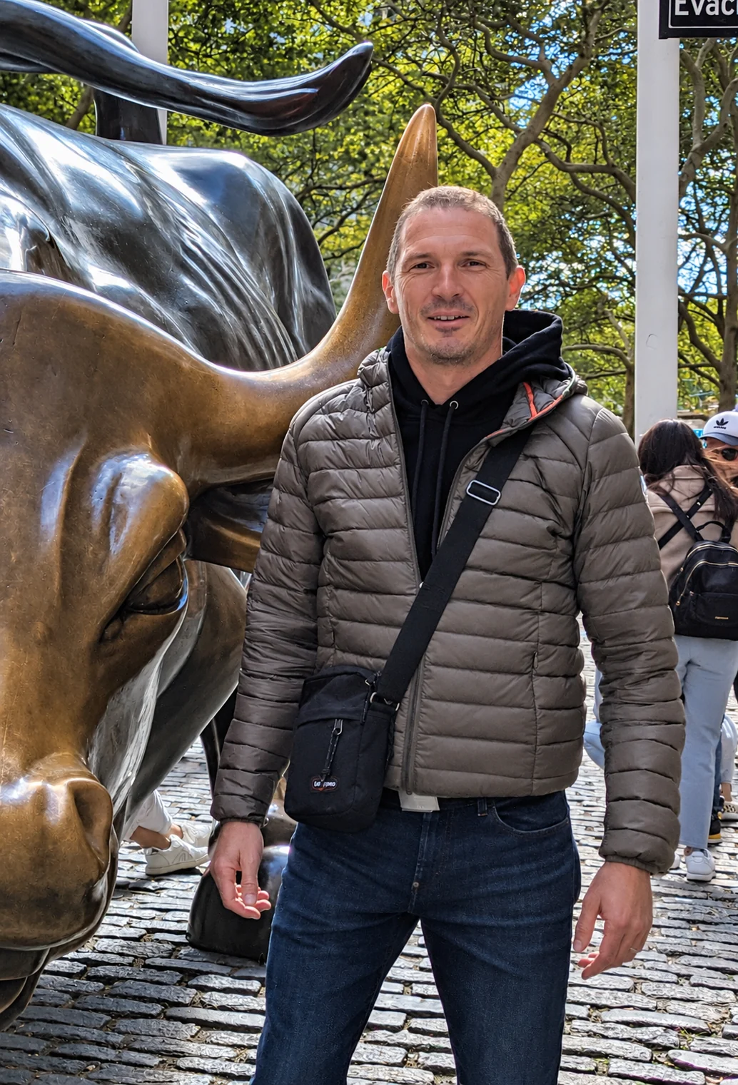 Aurélien Pasquier beside the Charging Bull sculpture in New York